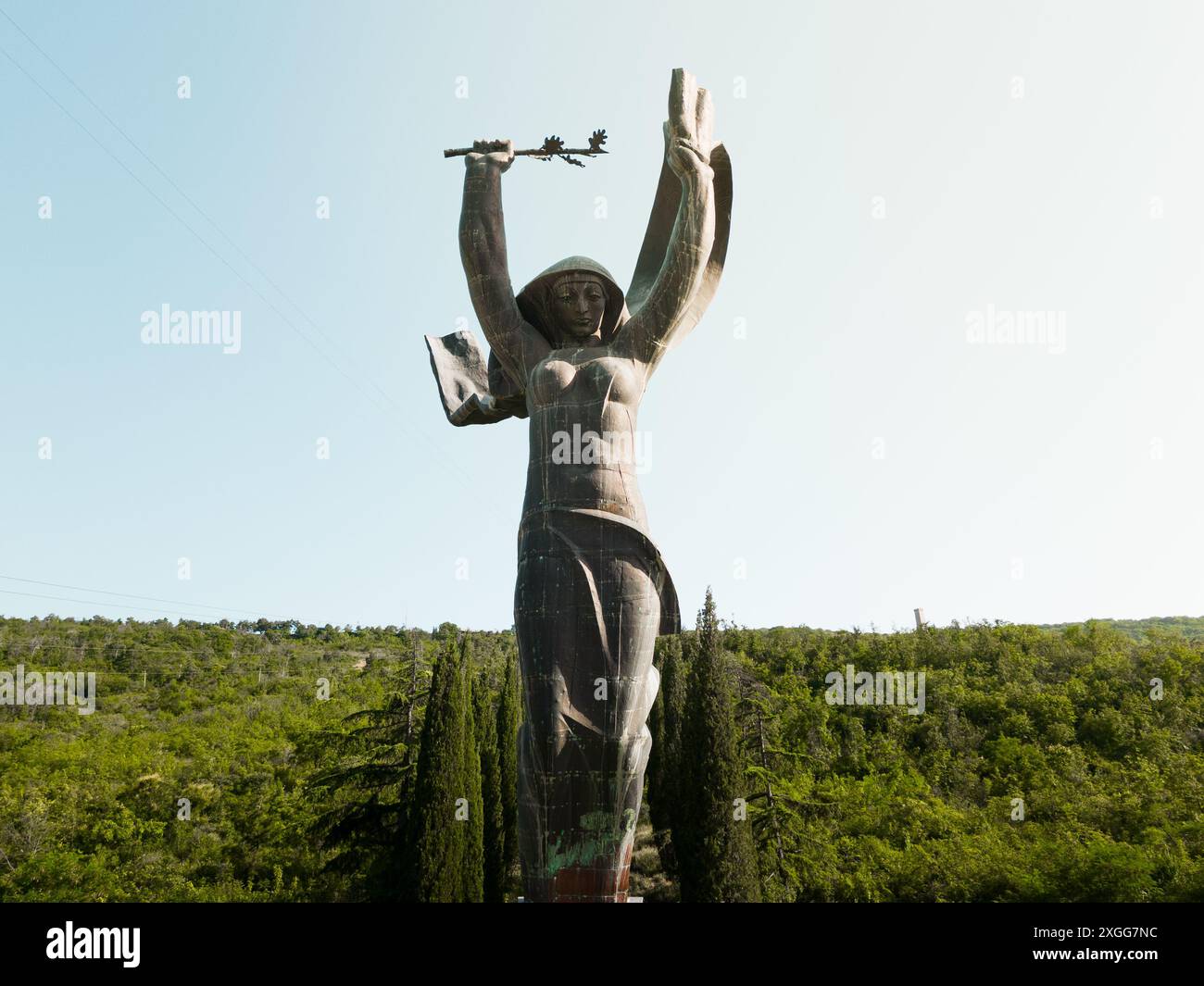 Tiflis, Georgien, 4. juli 2024: Beliebte riesige sowjetische Architekturstatue. Das Denkmal des Ruhmes - Frau, die ihre Arme hebt und ein Banner hält Stockfoto