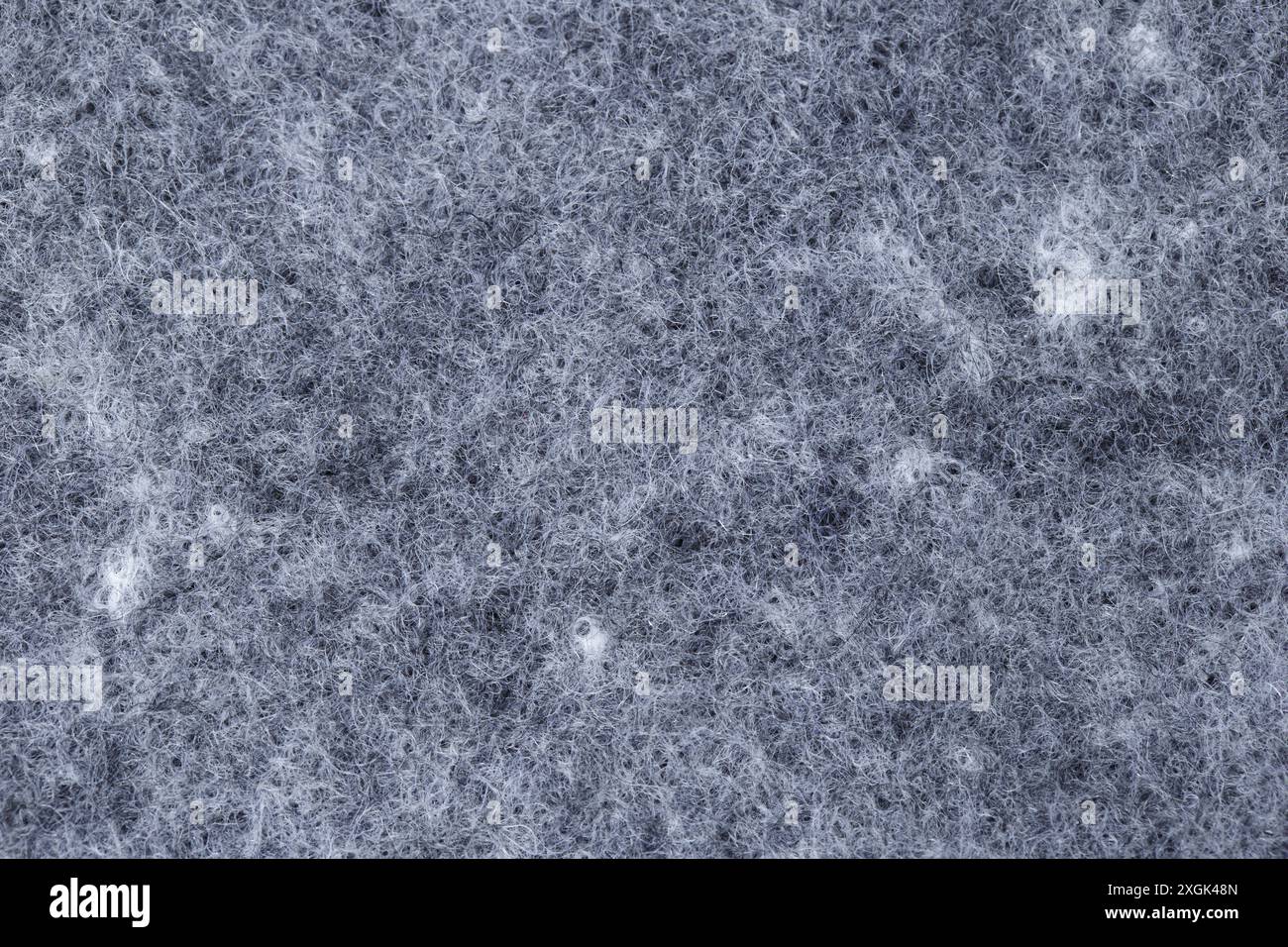 Detail der Textur eines grauen und weißen Fadenteppichs. Stockfoto