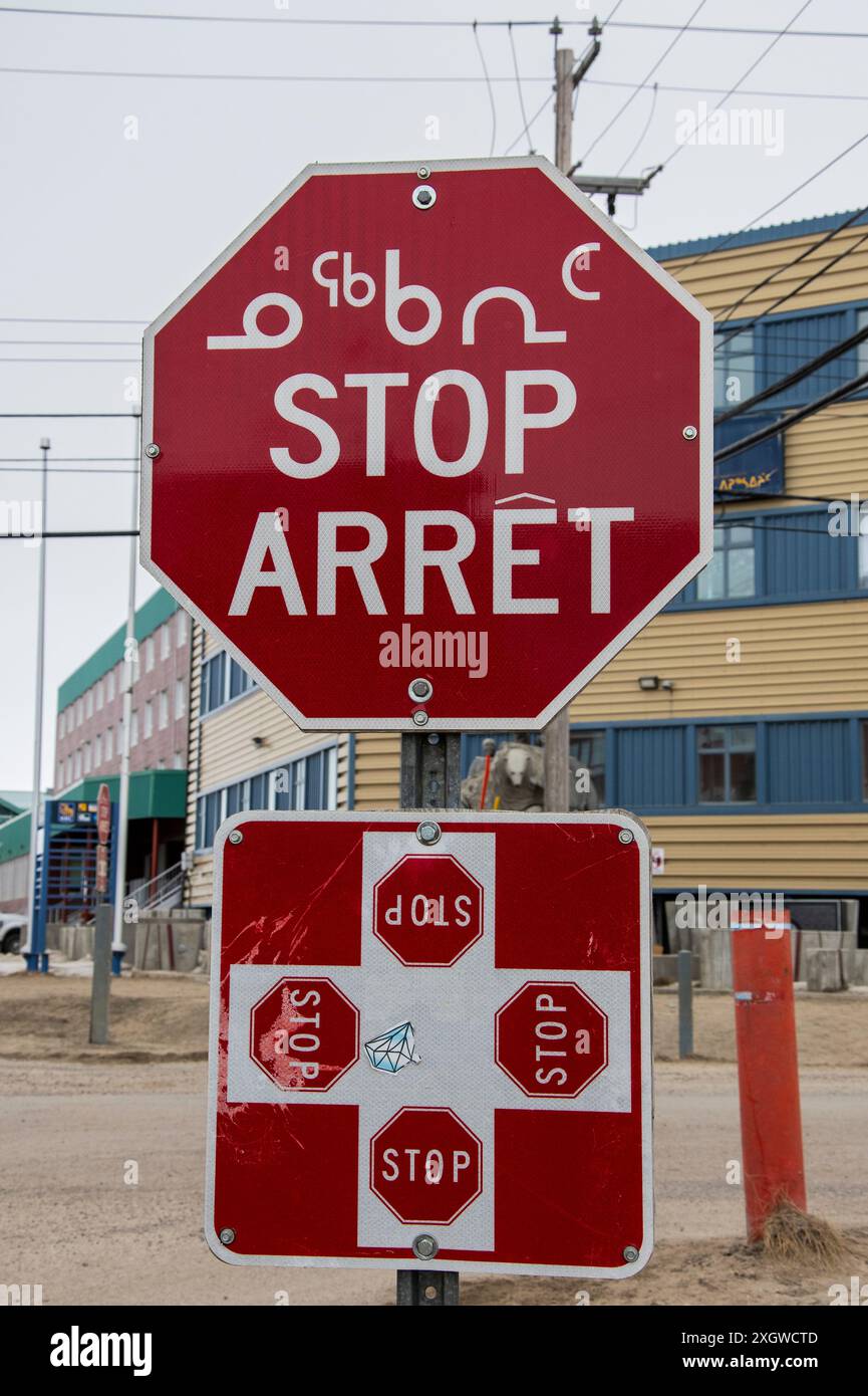 Mehrsprachiges Stoppschild auf Englisch, Französisch und Inuktitut an den Four Corners in Iqaluit, Nunavut, Kanada Stockfoto