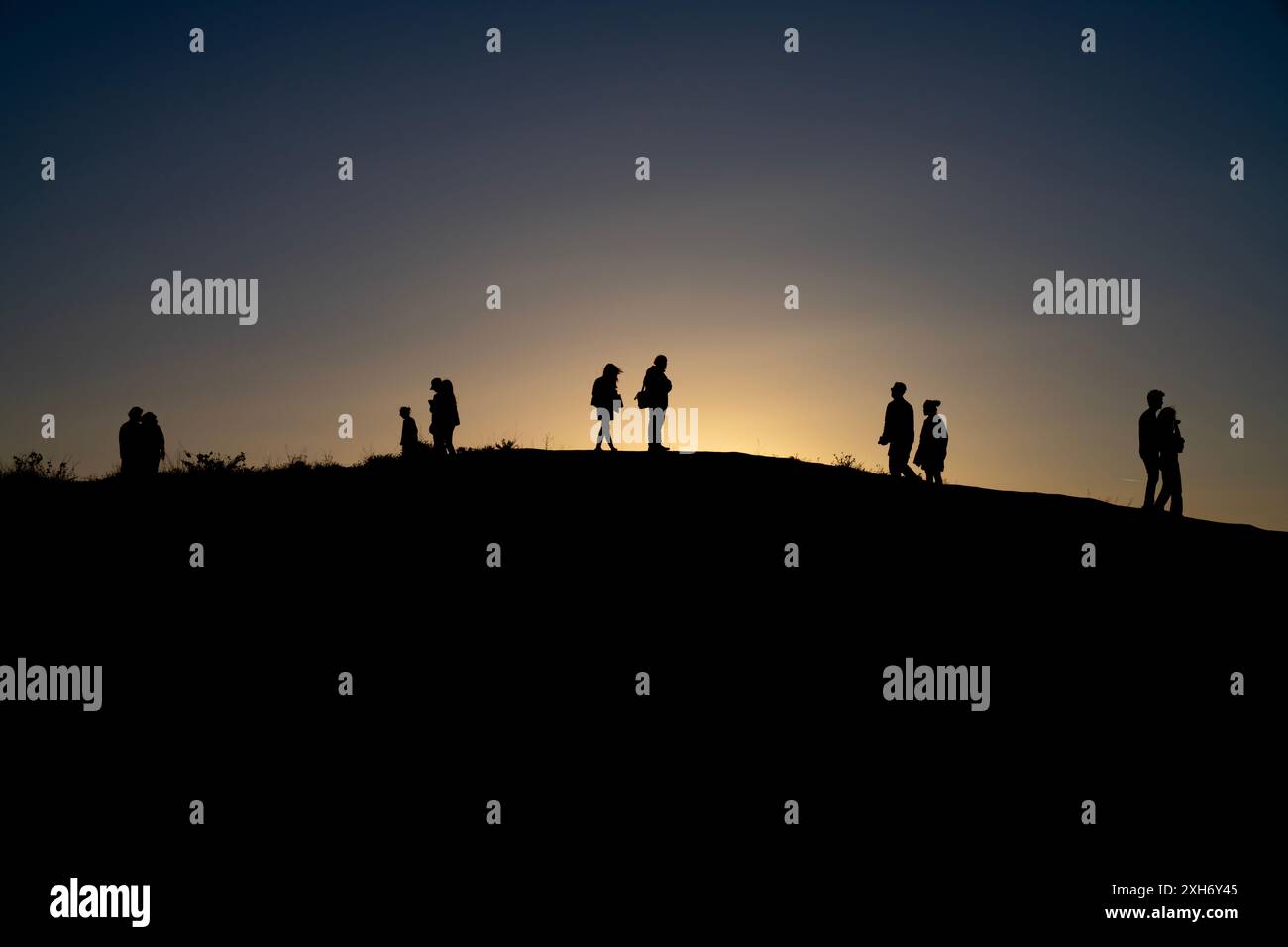 Silhouetten von Menschen auf dem Hügel. Silhouette People Sunrise Stockfoto