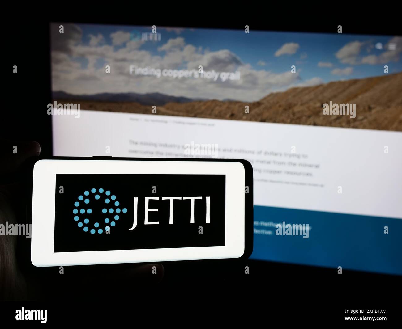 Person, die ein Smartphone mit dem Logo des US-amerikanischen Kupfergewinnungsunternehmens Jetti Resources LLC vor der Website hält. Schwerpunkt auf dem Display des Telefons. Stockfoto