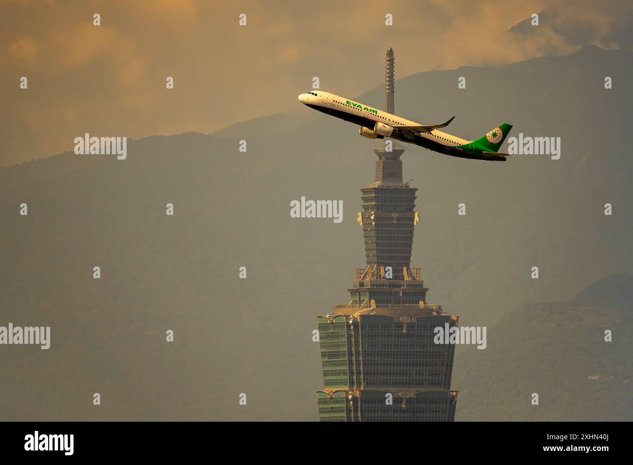 Flugzeug im Flug und Taipeh 101 im Hintergrund Stockfoto