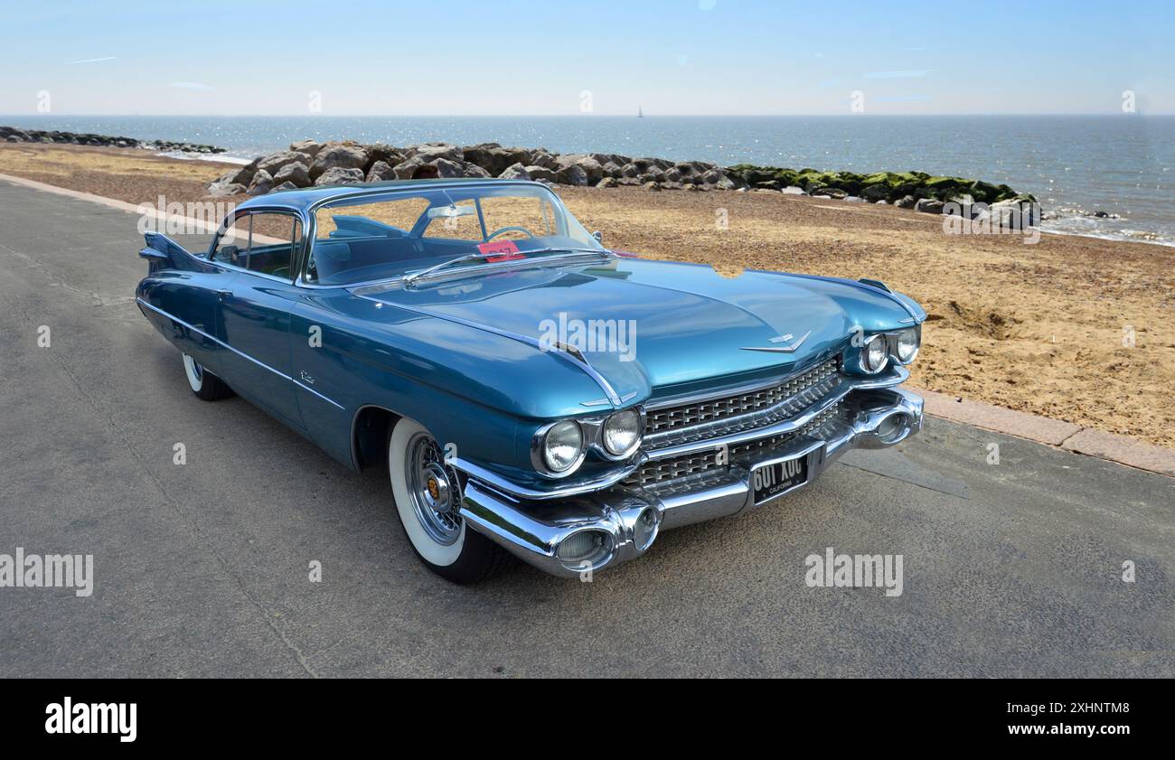 Klassischer amerikanischer Blue Cadillac-Motor, der an der Strandpromenade am Strand und am Meer im Hintergrund geparkt ist. Stockfoto