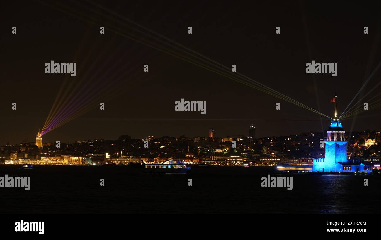 Ein Nachtfoto mit Langzeitbelichtung zeigt eine synchronisierte Lichtshow zwischen dem Maidenturm (Kız Kulesi) und dem Galatenturm in Istanbul. Stockfoto