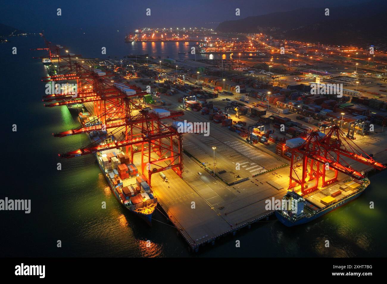 LIANYUNGANG, CHINA - 15. JULI 2024 - Frachtschiffe entladen Container am Containerterminal des Hafens Lianyungang, Provinz Jiangsu im Osten Chinas, Juli Stockfoto