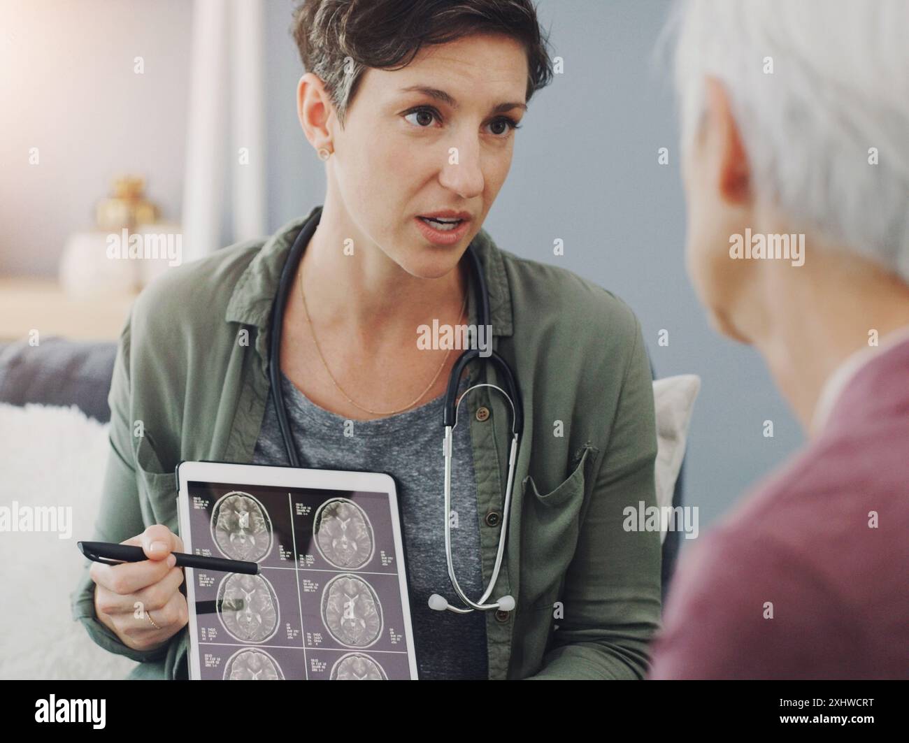 Ältere Frau, Arzt und Gehirn-Scan mit Tablette, Röntgen und MRT Ergebnisse im Krankenhaus mit Operationsplanung. Gesundheitswesen, CT und Anatomieanalyse für Stockfoto