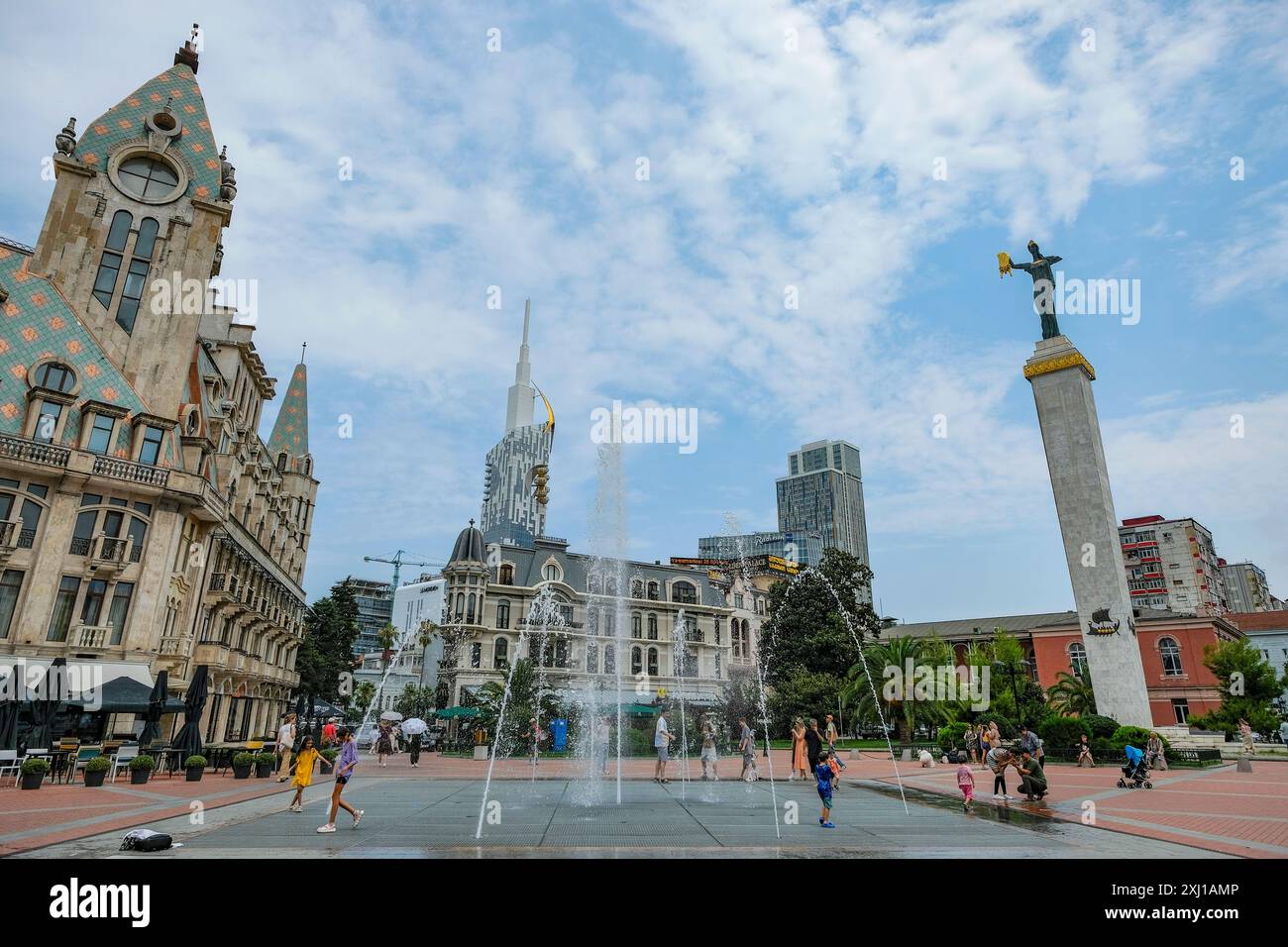 Batumi, Georgien - 16. Juli 2024: Menschen spielen in Batumi, Georgien, am Brunnen des Europa-Platzes mit der Medea-Statue im Hintergrund. Stockfoto