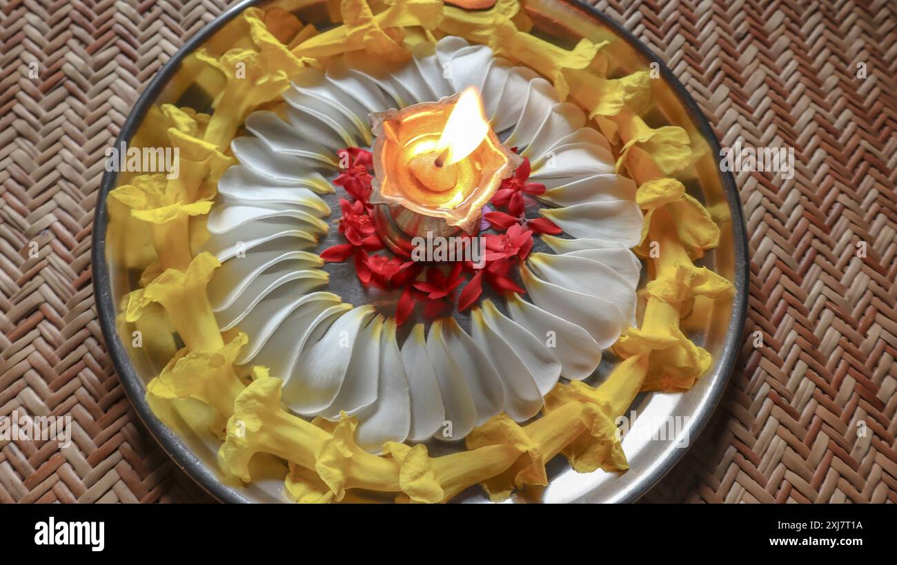 Wunderschöner aarti-Thali mit bunten Blumen und Diya-Öllampe. Hindufeste rituelle Tradition Stockfoto