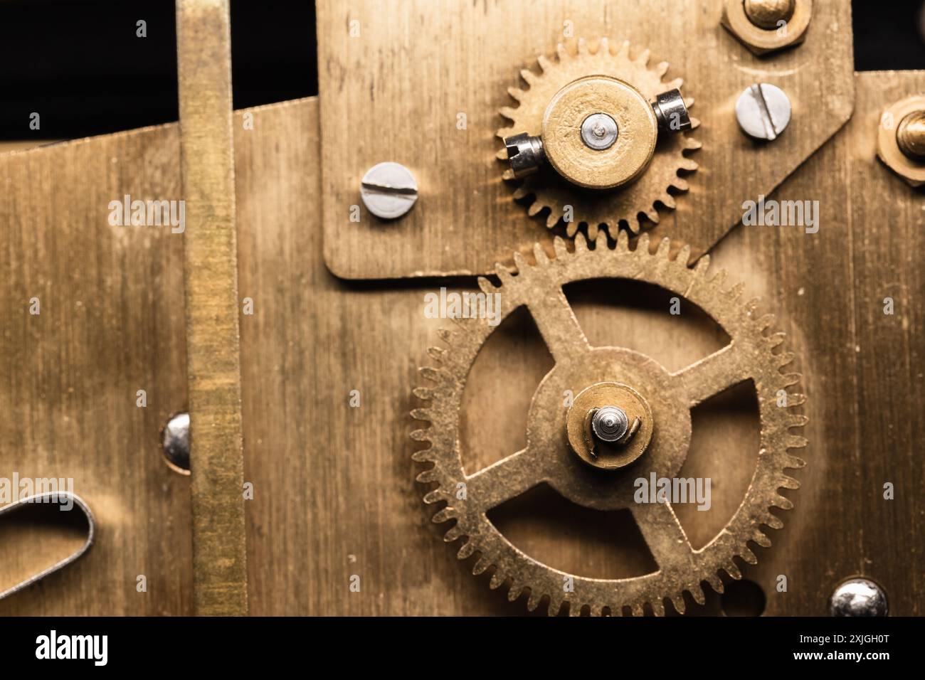 Vintage-Uhr Details Nahaufnahme mit selektivem Fokus, Zahnräder aus Messing befinden sich auf der Rückseite einer Kaminuhr Stockfoto