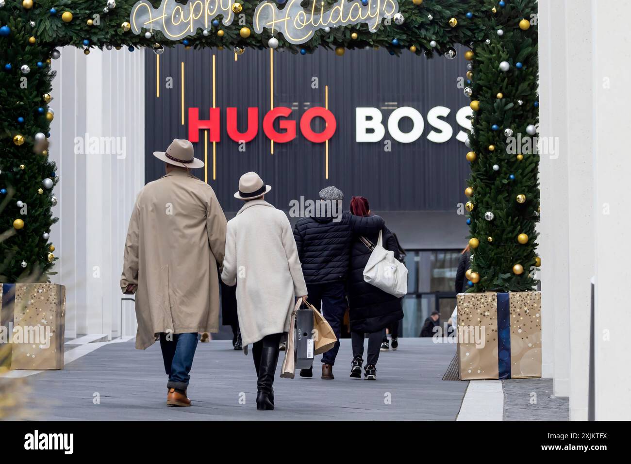 Weihnachtseinkäufe im Outletcity Metzingen. Konsumenten tragen Einkaufstaschen. Fabrikverkauf mit rund 80 Geschäften von Premium- und Luxusmarken Stockfoto