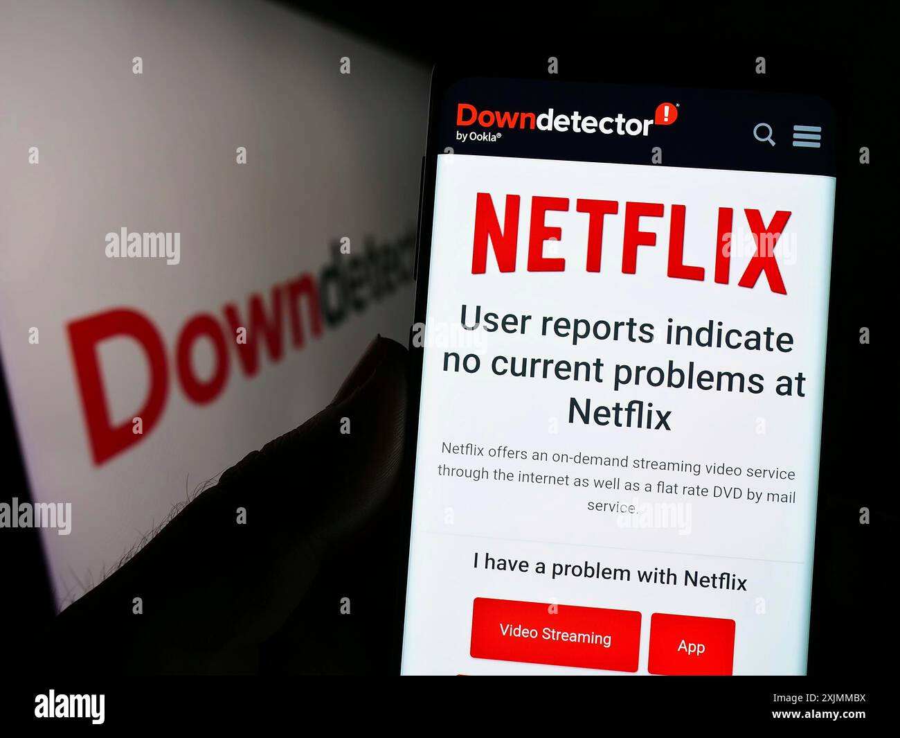 Stuttgart, Deutschland, 09-08-2022: Person, die ein Smartphone hält, mit Website des Plattform-Downdetektors und Netflix-Status vor dem Logo. Konzentrieren Sie sich auf das Telefon Stockfoto