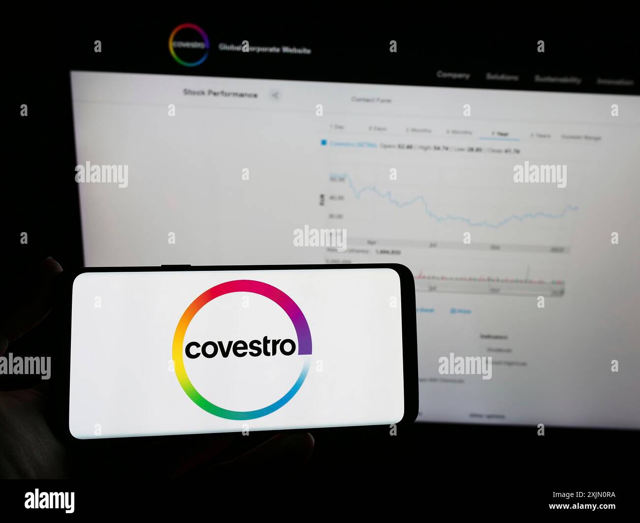 Stuttgart, 24.01.2023: Person mit Mobiltelefon mit Logo des deutschen Chemieunternehmens Covestro AG auf dem Bildschirm vor dem Business Web Stockfoto
