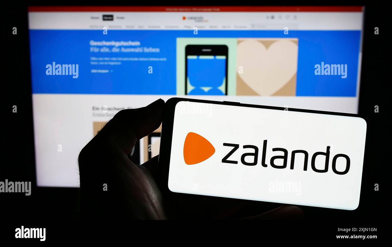 Stuttgart, Deutschland, 16.01.2023: Person, die ein Smartphone mit dem Logo des deutschen E-Commerce-Unternehmens Zalando SE auf dem Bildschirm vor der Website hält. Konzentrieren Sie sich auf Stockfoto