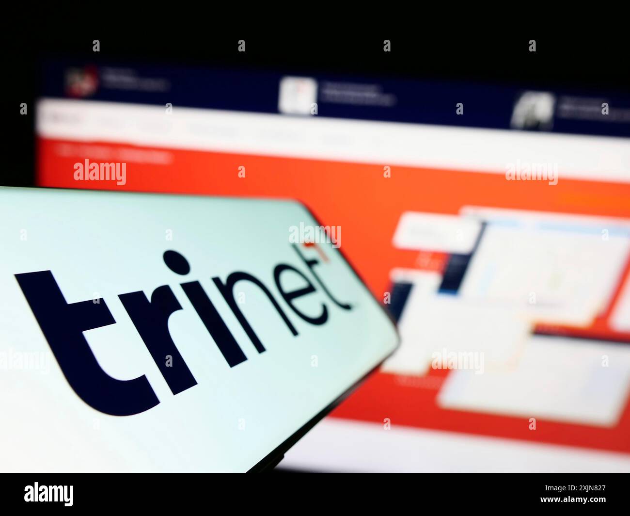 Stuttgart, 18.06.2023: Mobiltelefon mit Logo des amerikanischen Outsourcing-Unternehmens TriNet Group Inc. Auf dem Bildschirm vor der Business-Website. Stockfoto Stuttgart, 18.06.2023: Mobiltelefon mit Logo des amerikanischen Outsourcing-Unternehmens TriNet Group Inc. Auf dem Bildschirm vor der Business-Website. Stockfoto