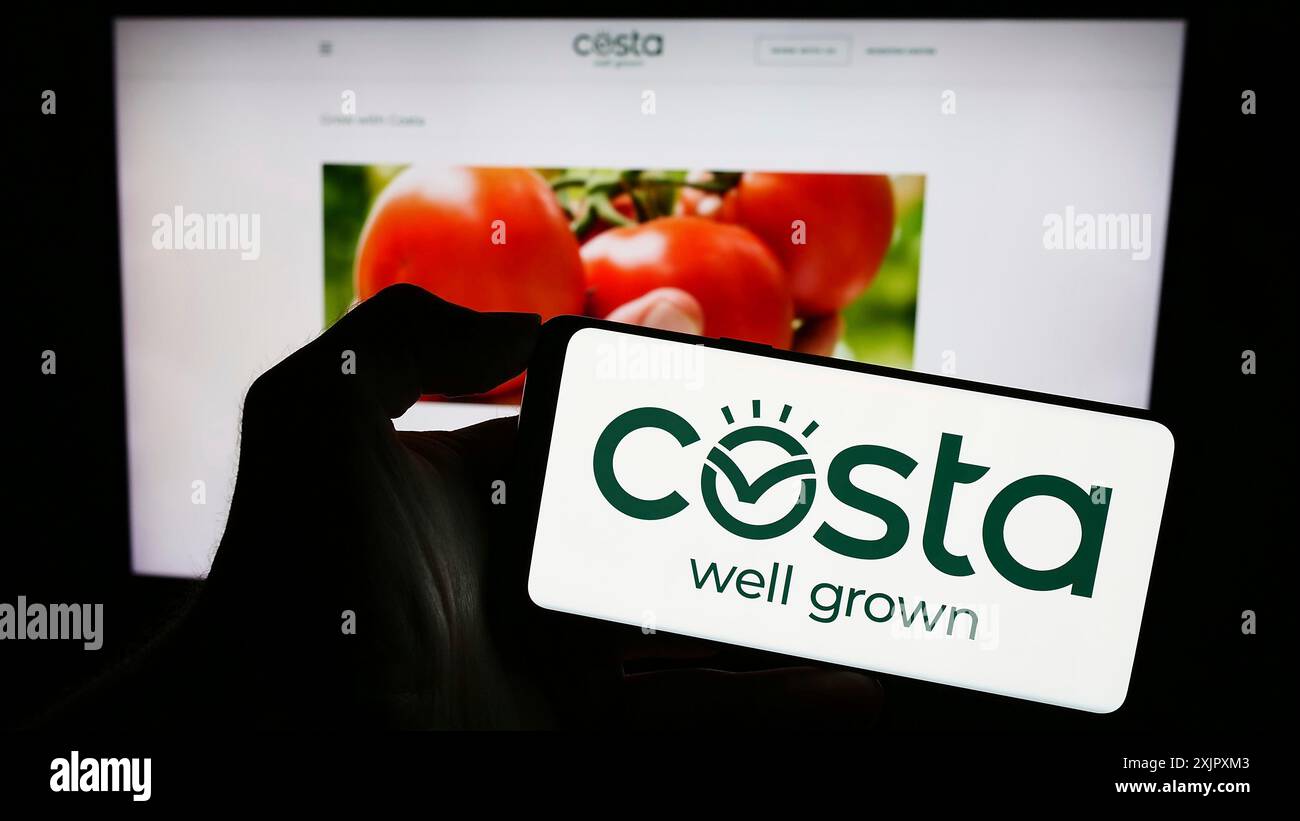 Stuttgart, Deutschland, 10.11.2023: Person, die ein Mobiltelefon mit dem Logo des australischen Unternehmens Costa Group Holdings Limited vor der Webseite hält. Stockfoto