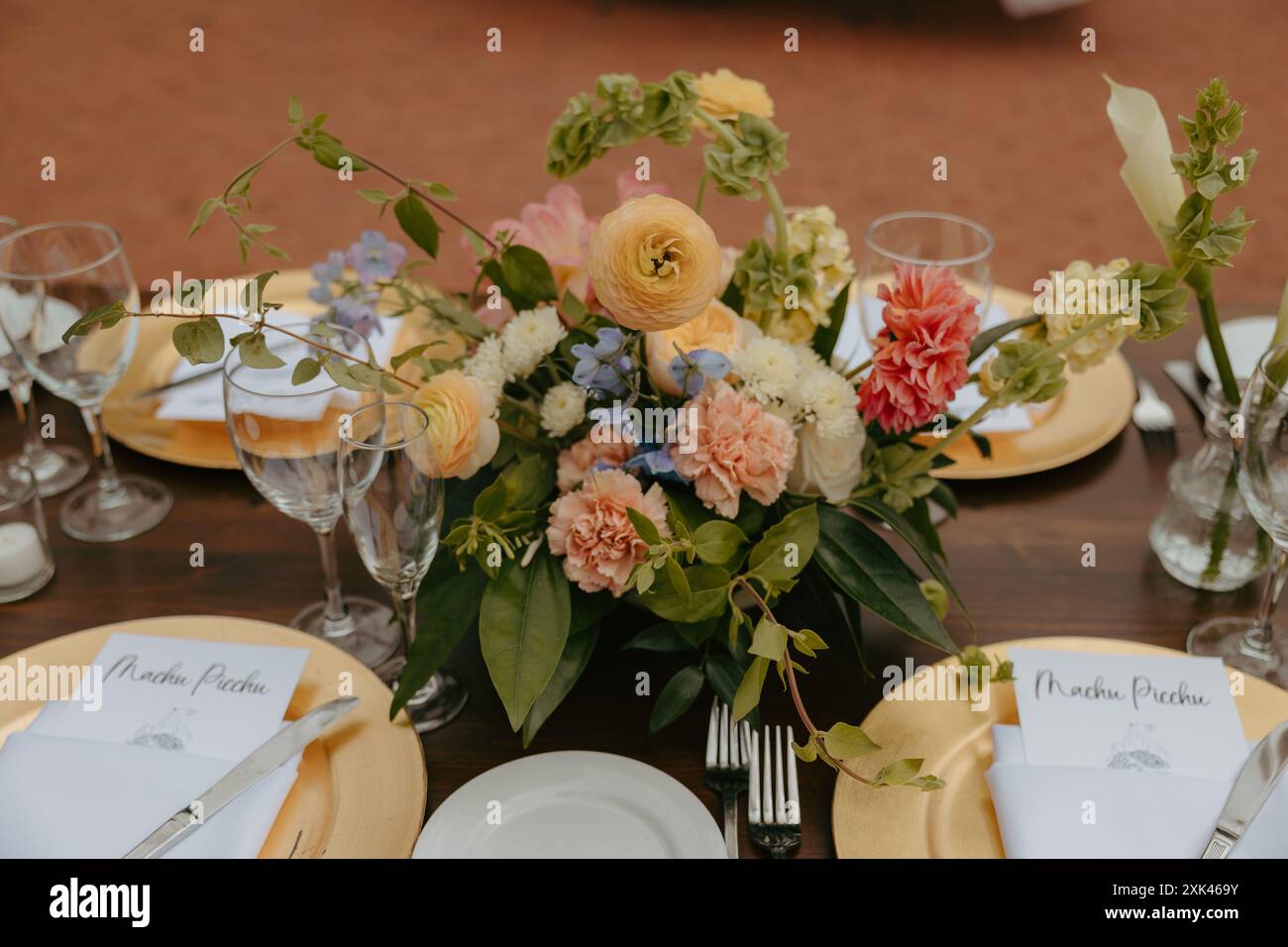 Ein wunderschön gestalteter Hochzeitstisch mit Blumenmotiv und elegantem Geschirr Stockfoto