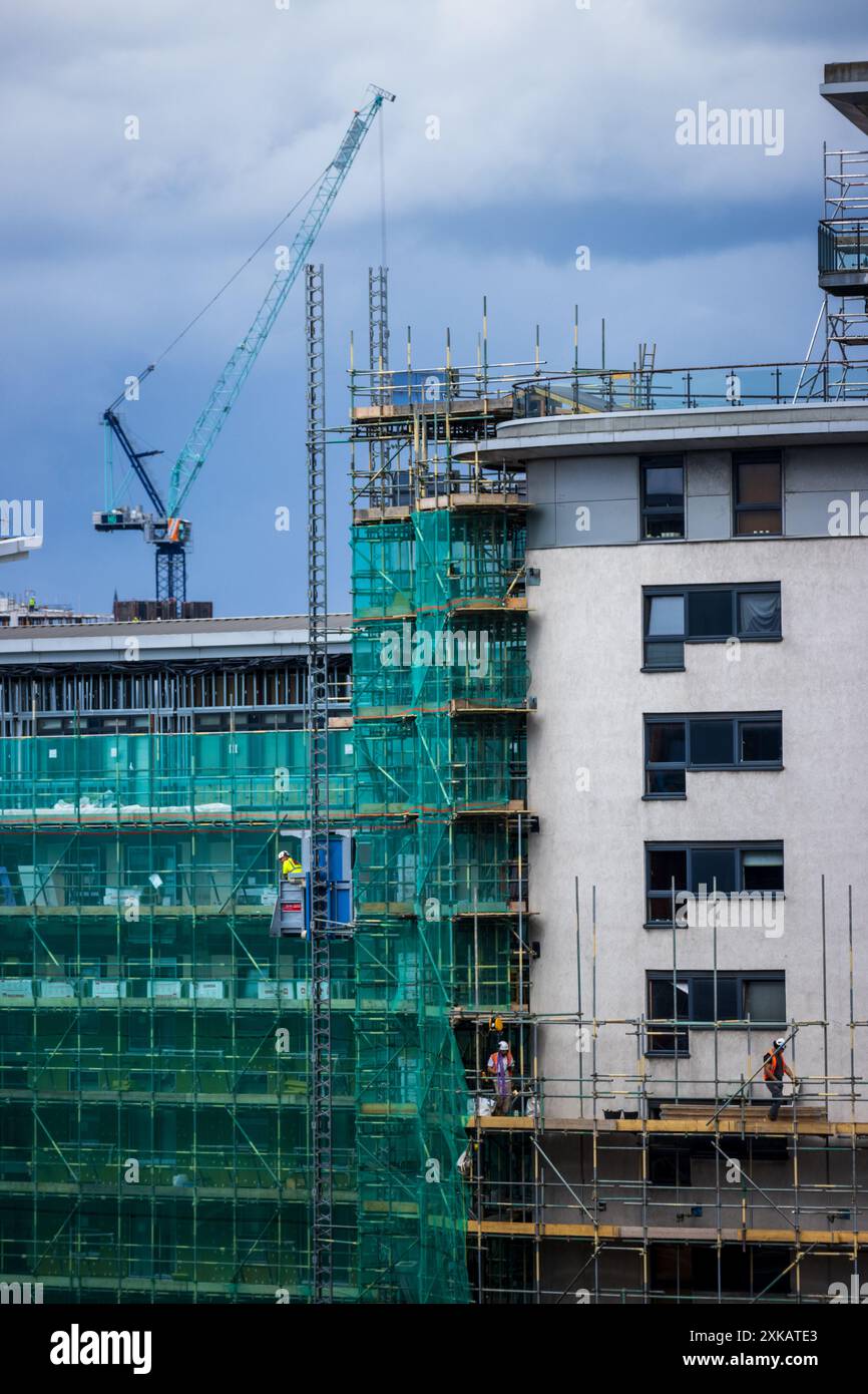 Gerüstbau am Magellan House am Leeds Dock in Yorkshire, England während der Brandschutzarbeiten, um gefährliche Verkleidungen von der Außenseite der Wohnungen zu entfernen Stockfoto