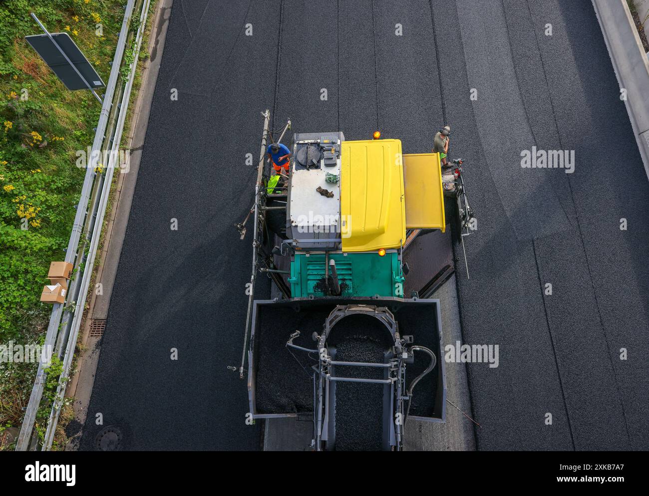 Essen, Nordrhein-Westfalen, Deutschland - Straßenbau, Asphaltfertiger und Straßenwalzen verlegen neuen, offenporigen, fluestergetrockneten Asphalt auf der A52 Mo Stockfoto