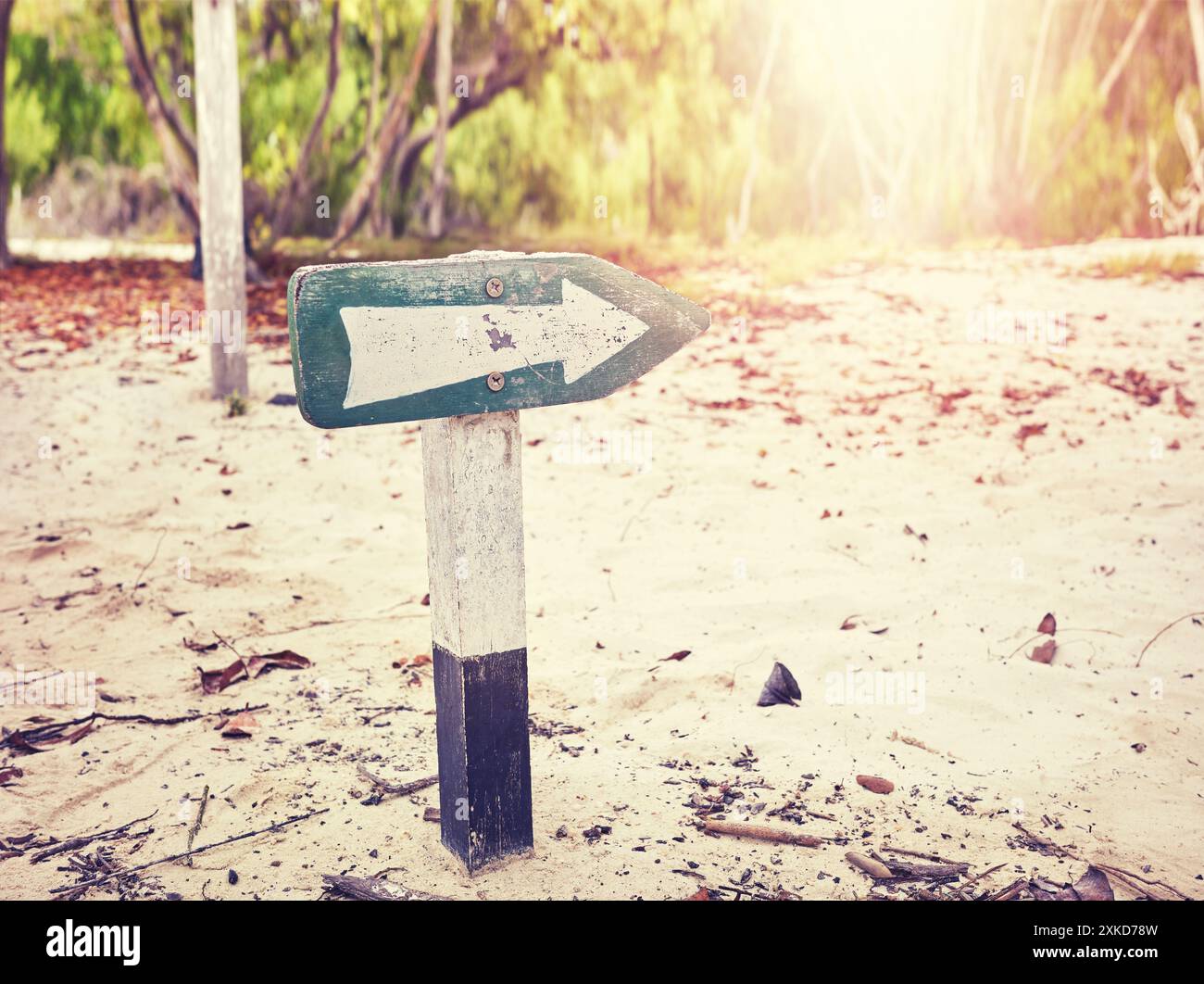 Richtungspfeil am Strand, selektiver Fokus, Farbton angewendet. Stockfoto