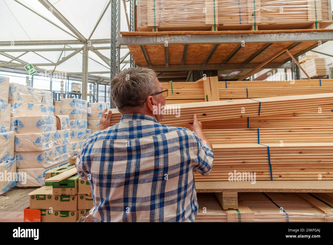 Título: Pensionierter hispanischer Mann in seinen 70ern wählte Holz, um im Laden zu kaufen, um sein Haus zu renovieren Stockfoto