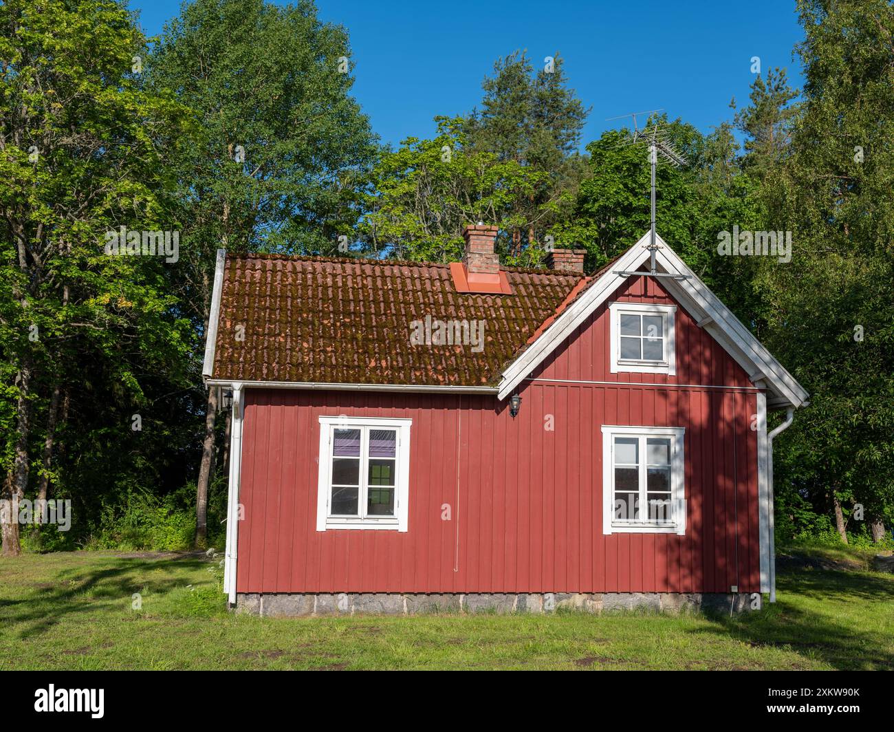 Schwedisches rotes Cottage. Traditionelles Holzhaus mit weißen Ecken Stockfoto
