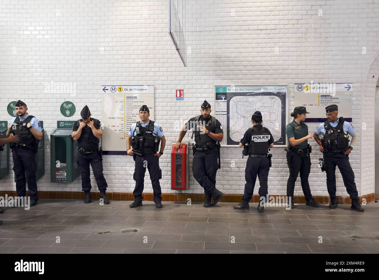 Paris, Frankreich. Juli 2024. Am Donnerstag, den 25. Juli 2024, kurz vor der Eröffnungszeremonie der Olympischen Spiele, steht die Polizei hinter dem Eingang einer U-Bahn-Station in Paris, Frankreich. Die Sicherheit wurde mit rund 75.000 Polizisten, Soldaten und Sicherheitskräften in Alarmbereitschaft verstärkt. Foto: Maya Vidon-White/UPI Credit: UPI/Alamy Live News Stockfoto