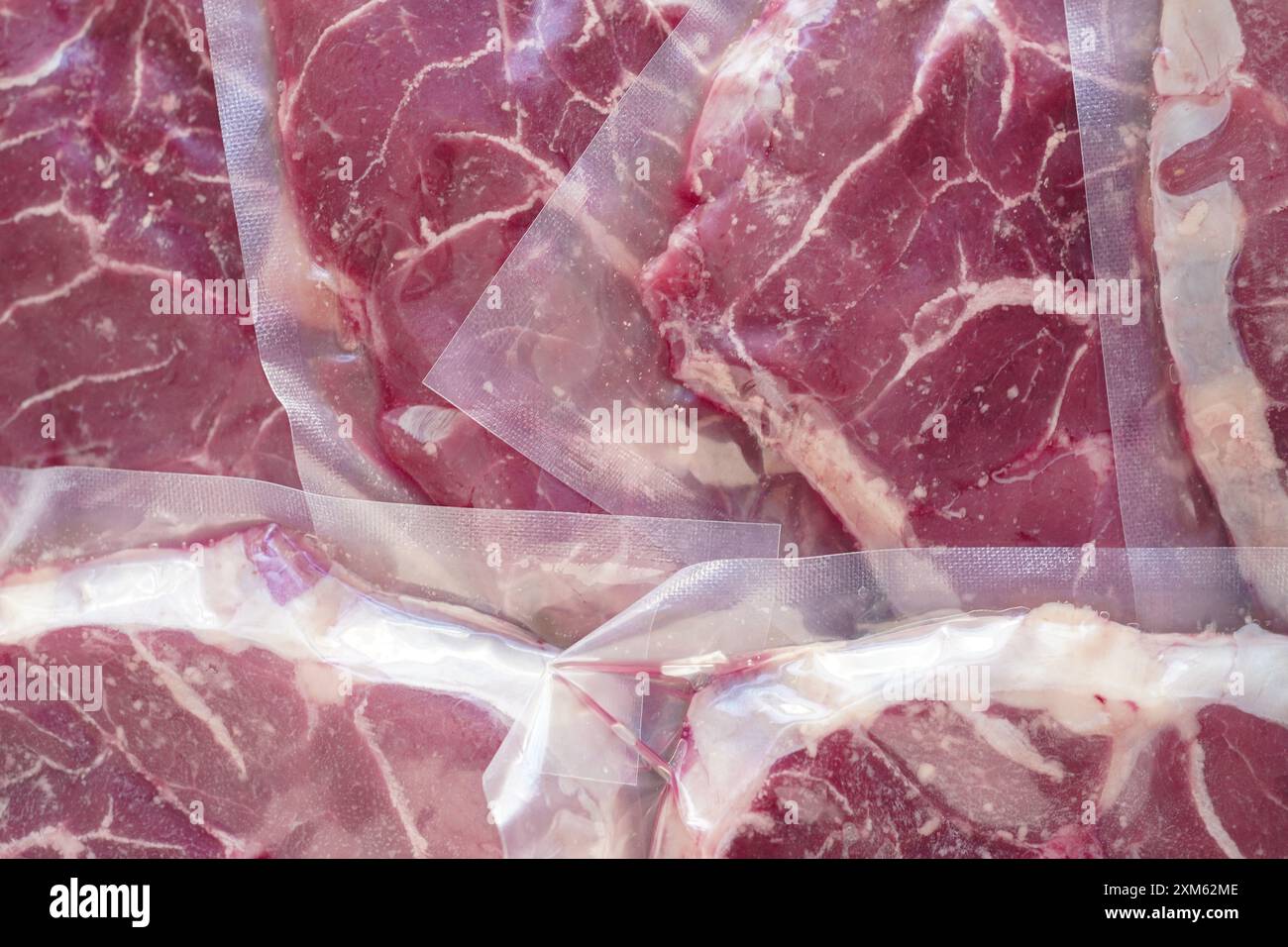 Großaufnahme von Bio-Rindfleisch (osso buco) in einer vakuumversiegelten Verpackung mit weißem Hintergrund Stockfoto