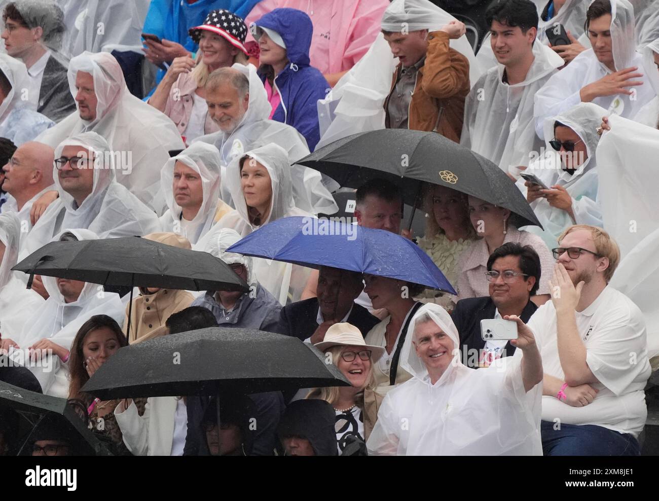 Paris, Frankreich. Juli 2024. Zuschauer mit Regenponchos nehmen Selfies, während sie auf den Beginn der Eröffnungszeremonie der Olympischen Spiele 2024 in Paris warten, Frankreich, Freitag, den 26. Juli 2024. Mehr als 10.000 Athleten aus 206 Ländern werden an den Olympischen Sommerspielen teilnehmen, die vom 26. Juli bis 11. August stattfinden. Foto: Richard Ellis/UPI Credit: UPI/Alamy Live News Stockfoto