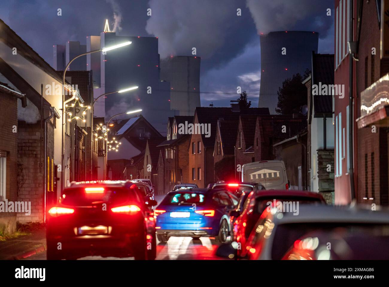 Das Dorf Vanikum, Teil der Gemeinde Rommerskirchen, Hauptstraße, dahinter das Braunkohlekraftwerk Neurath, bei Grevenbroich Stockfoto