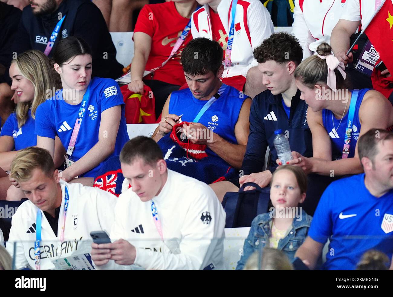 Der britische Tom Daley strickt, während er am ersten Tag der Olympischen Spiele in Paris 2024 in Frankreich das 3-m-Springboard-Finale der Frauen im Aquatics Centre ansieht. Bilddatum: Samstag, 27. Juli 2024. Stockfoto