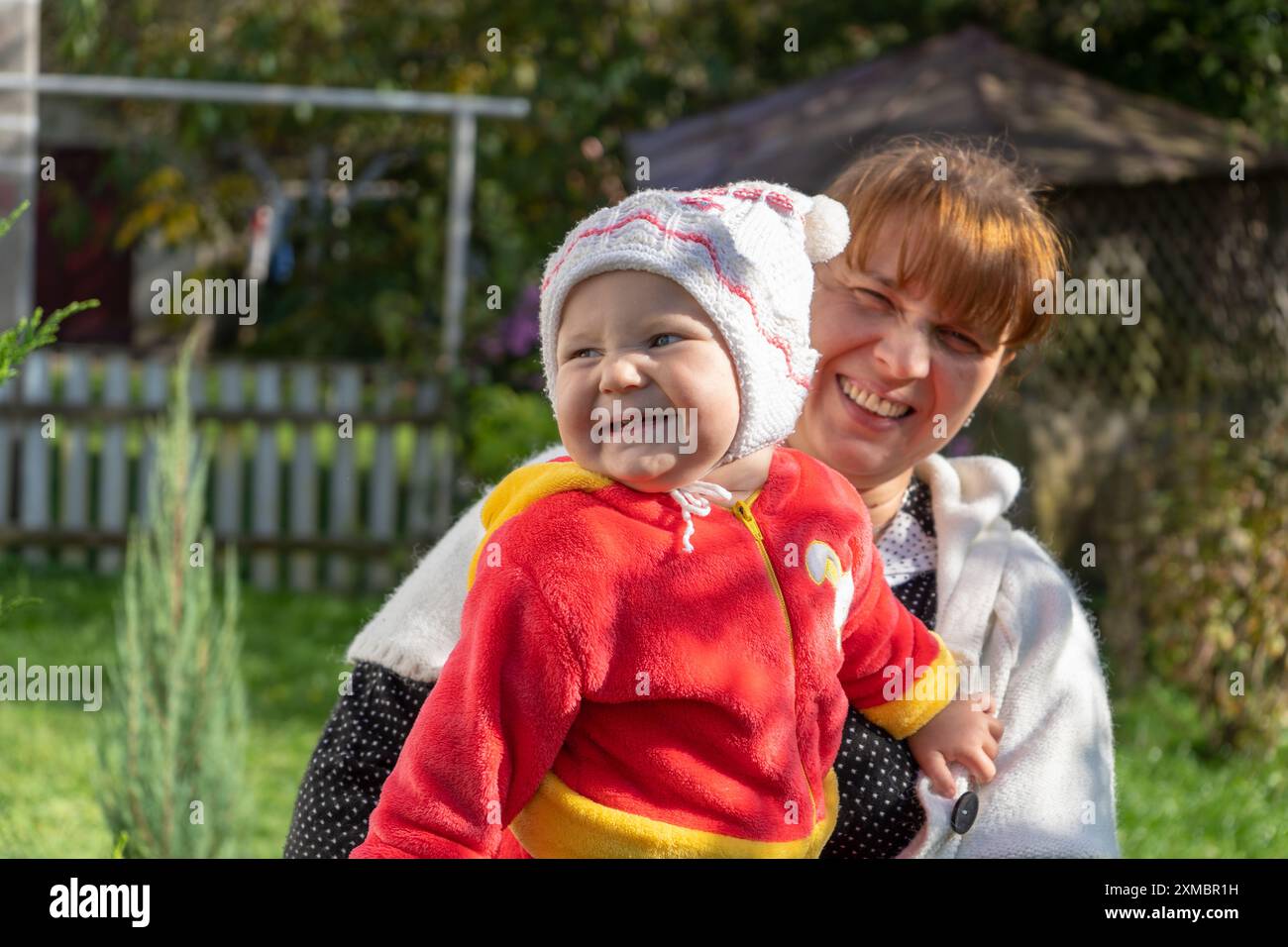 Fröhliches kleines Mädchen lacht Mütter an die Seite Stockfoto