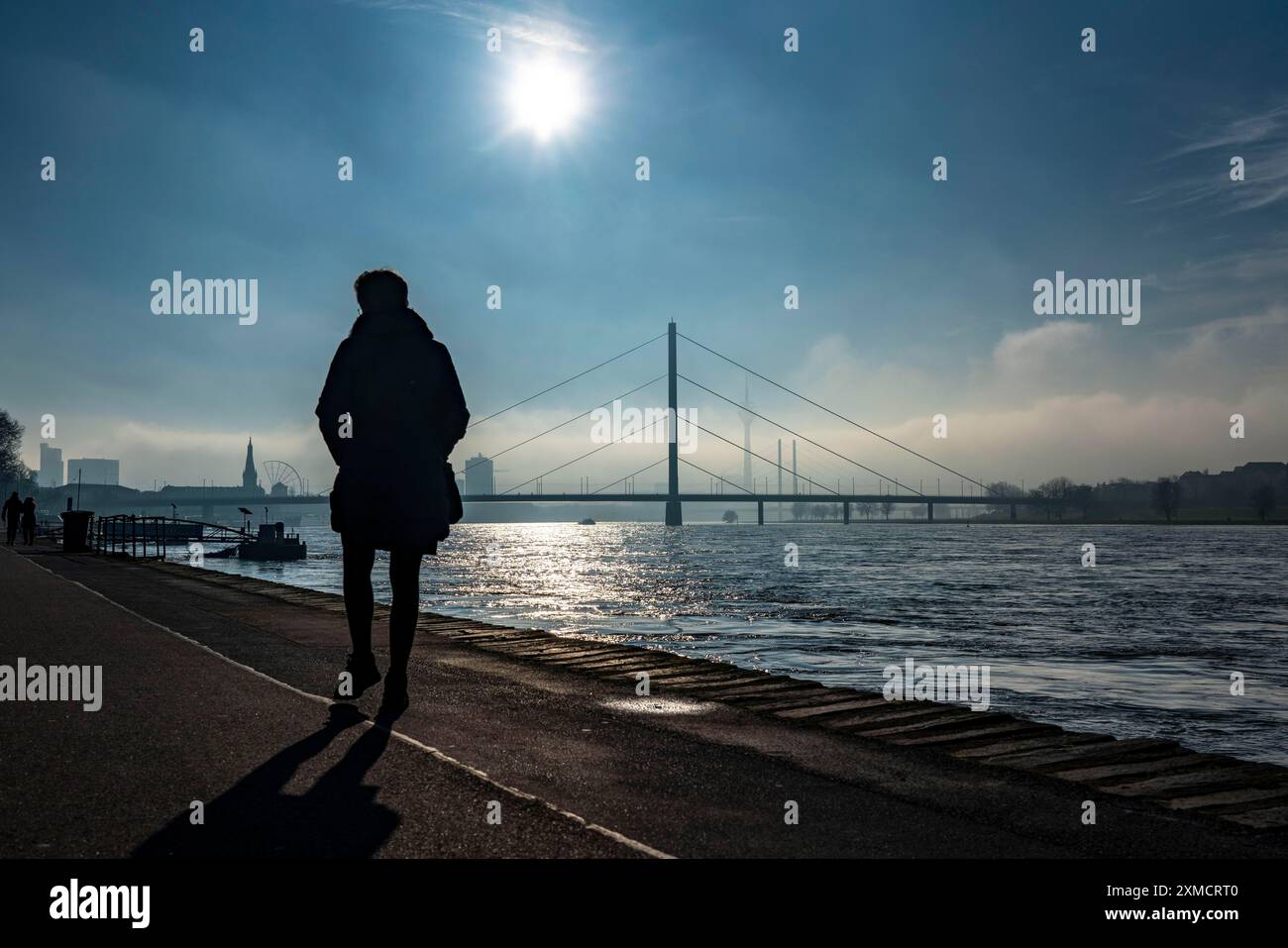 Dichter Nebel erhebt sich langsam, Uferpromenade am Rhein bei Düsseldorf, vor der Oberkassler Brücke, dahinter die Rheinknie Brücke Stockfoto