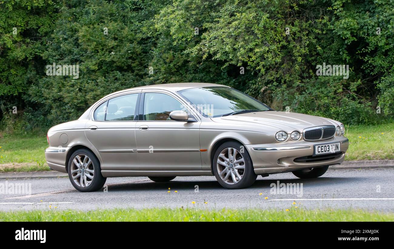 Milton Keynes, Großbritannien - 18. Juli 2024: 2003 beigefarbener Jaguar X-Typ, der auf einer britischen Landstraße fährt Stockfoto