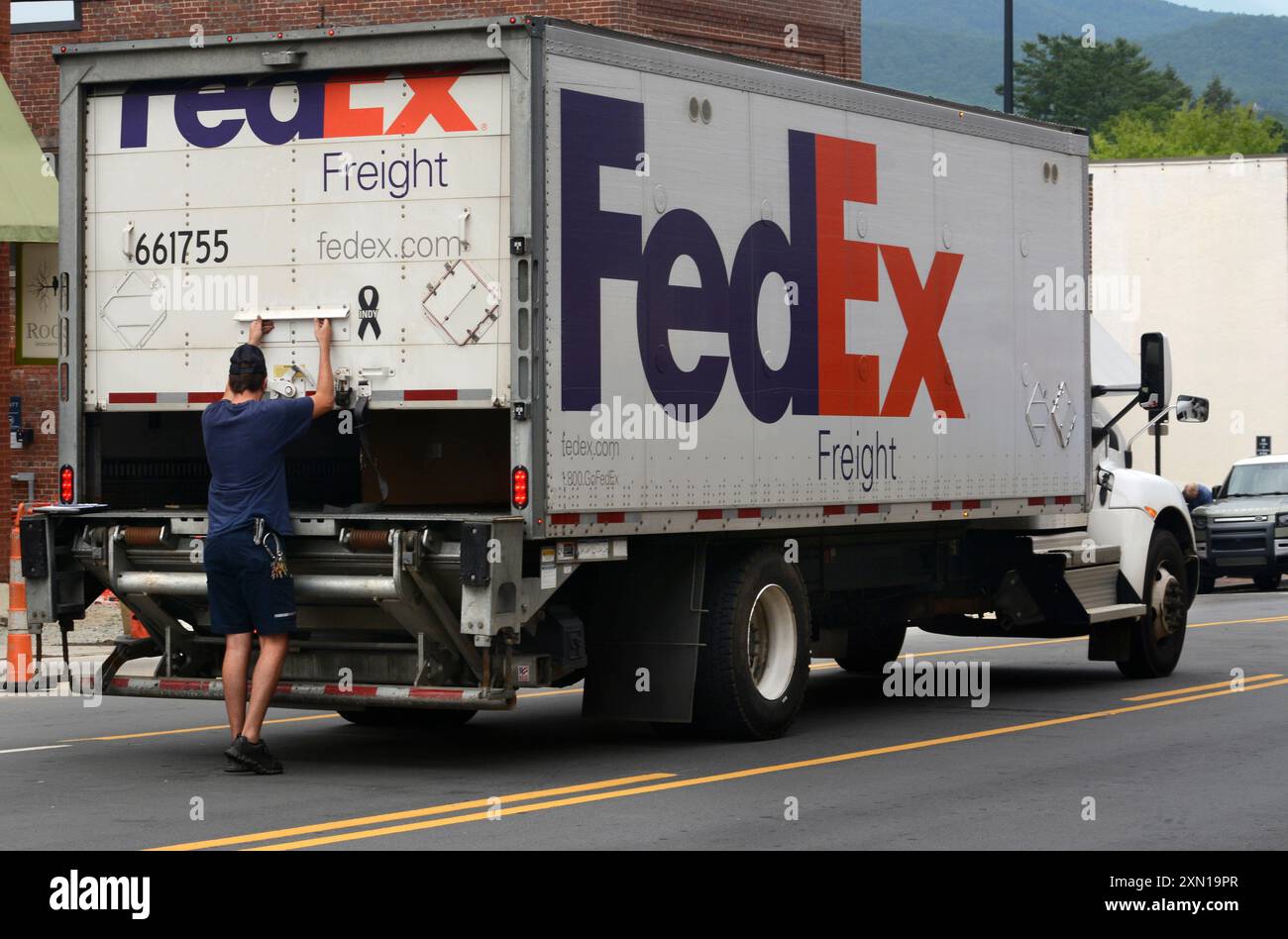 Ein FedEx- oder Federal Express-Lkw und -Lieferer liefern Waren an ein Einzelhandelsgeschäft in Brevard, North Carolina. Stockfoto