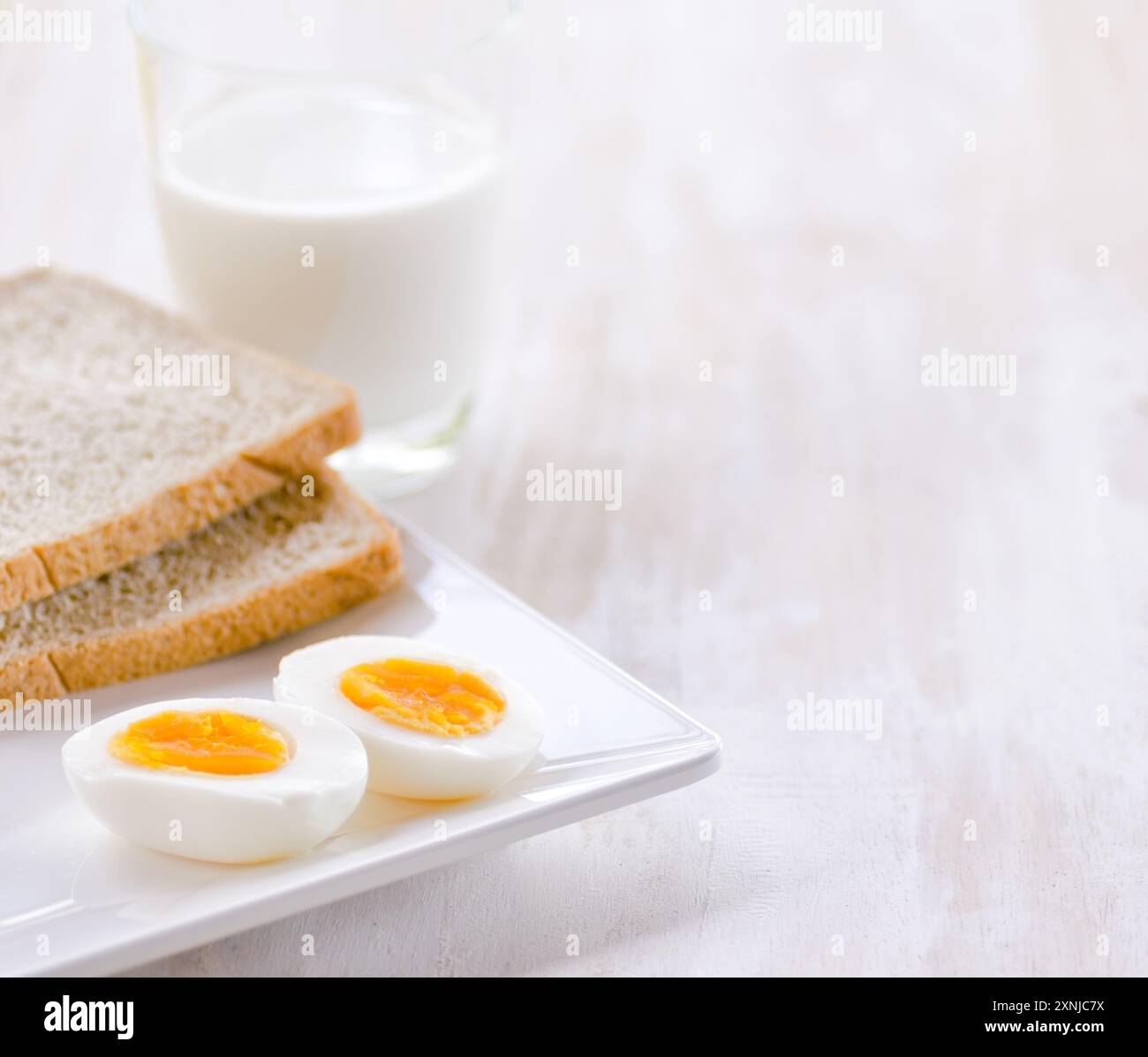 Gekochte Eier, Toast und ein Glas Milch Stockfoto