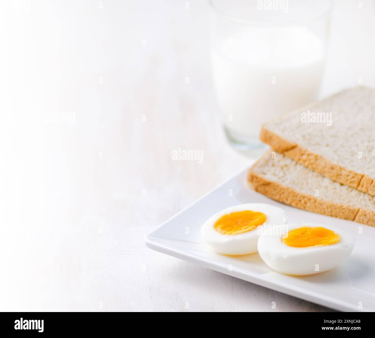 Gekochte Eier, Toast und ein Glas Milch Stockfoto