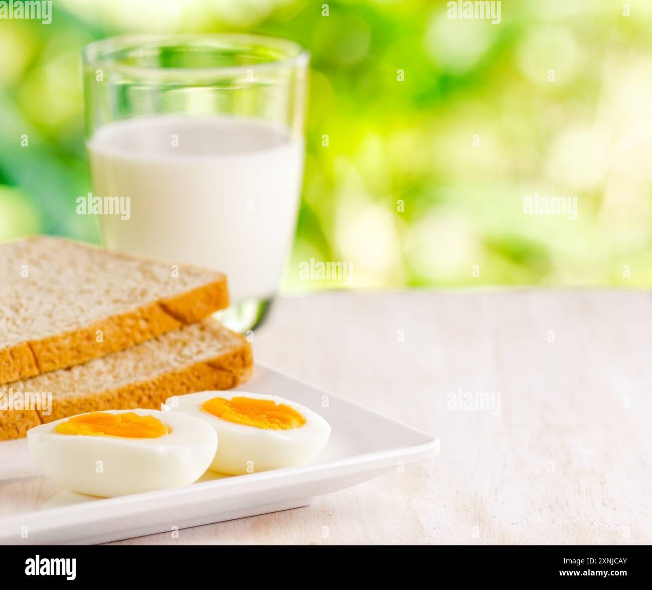Gekochte Eier, Toast und ein Glas Milch Stockfoto