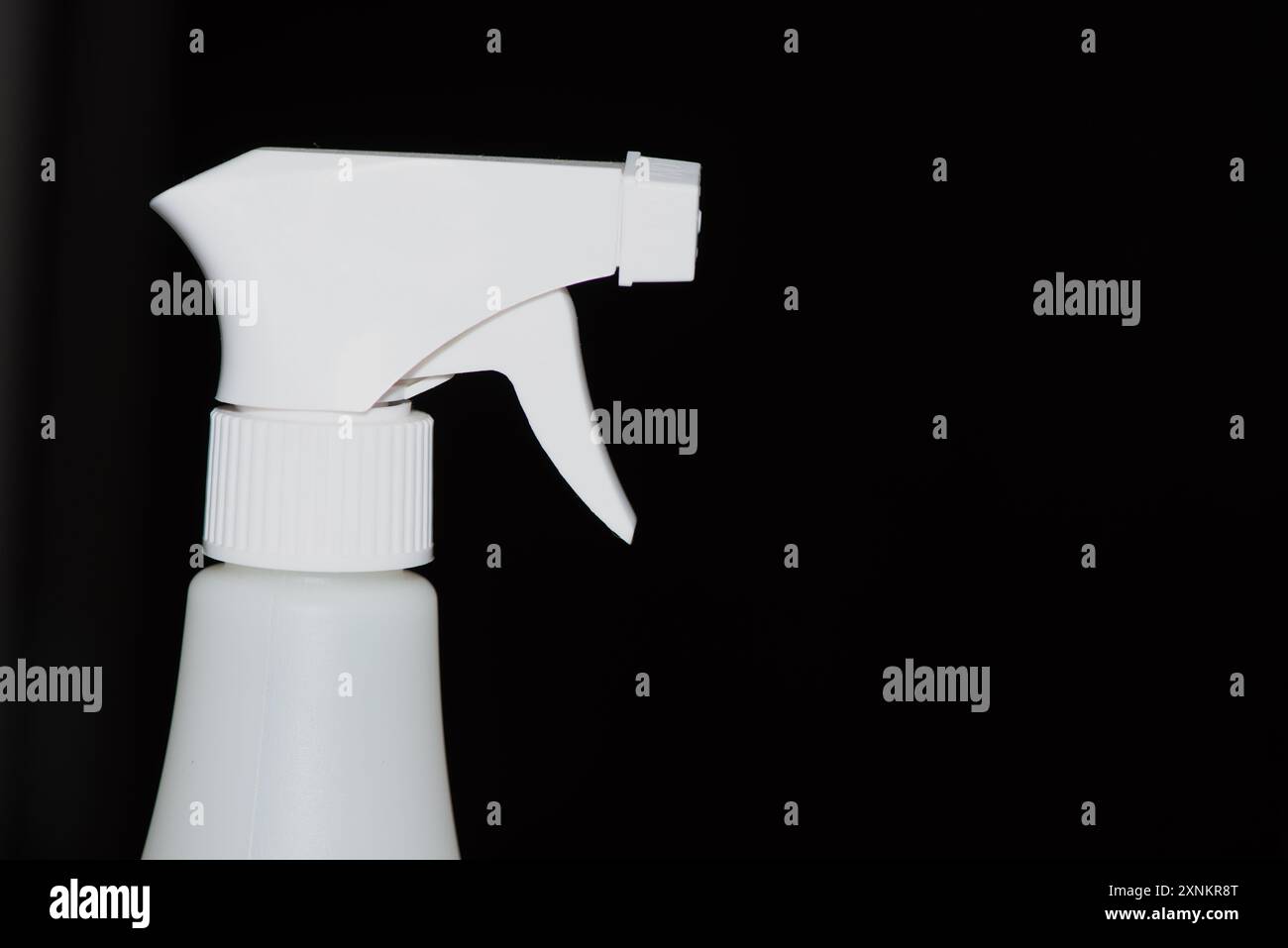 Ein Nahaufnahme des Kopfes einer Sprühflasche, in dem die Düse und der Auslösemechanismus für eine präzise Flüssigkeitsdosierung hervorgehoben werden. Stockfoto