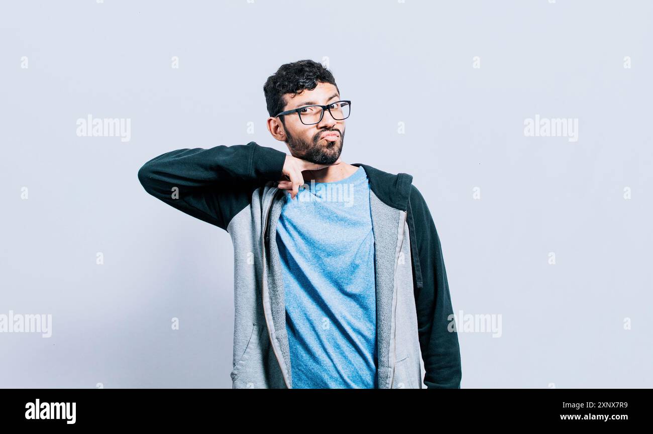 Person, die mit einem Finger in den Hals bedroht, isoliert. Mann mit gewalttätigem Blick, der bedrohliche Zeichen macht Stockfoto