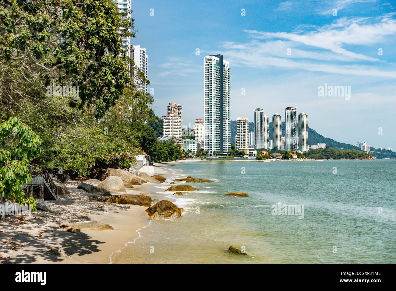 Ein Blick auf den Tanjing Tokong Strand in Penang, Malaysia, mit hohen, modernen Wolkenkratzern, Teil einer Stadtlandschaft im Hintergrund. Stockfoto