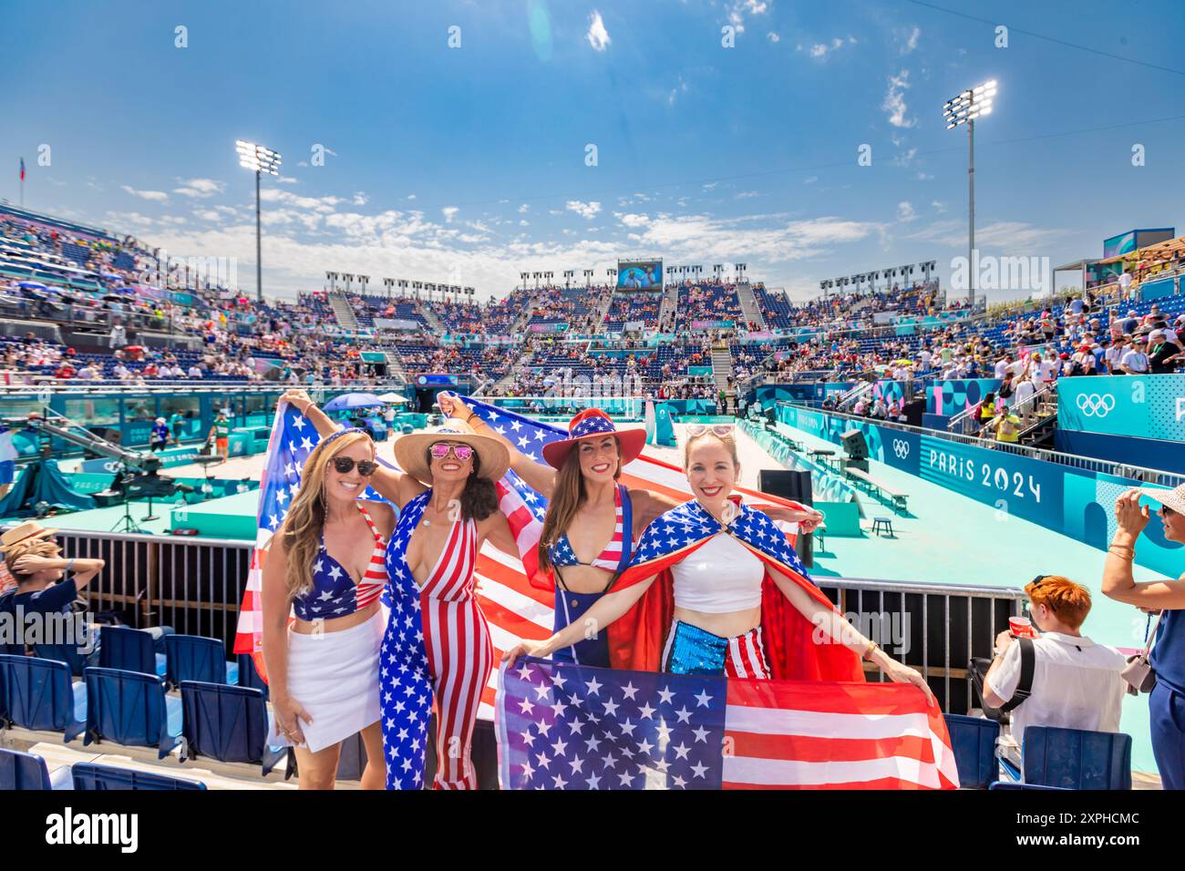 Patriotische Amerikanerin springt und jubelt für das Team USA und die Olympischen Spiele 2024 in Paris vor dem Eiffelturm, Paris, Frankreich, Europa Stockfoto