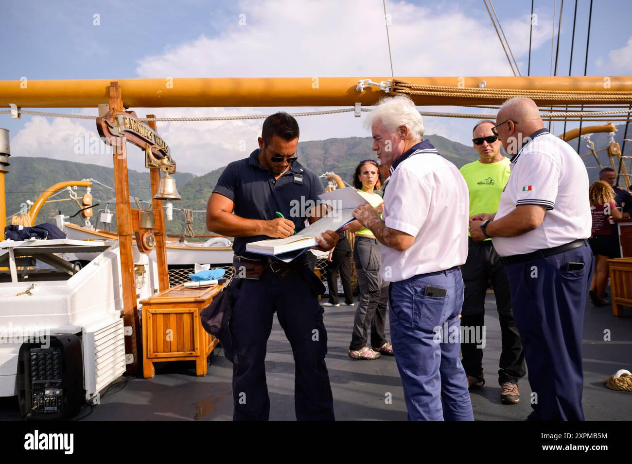 Scilla, Italien. August 2024. Ein Mitglied der Crew hat gesehen, wie er ein Gästebuch unterzeichnet hat. Eine Zeremonie für den 1995 auf mysteriöse Weise verstorbenen Kapitän Natale de Grazia fand an Bord des italienischen Marineschiffs Palinuro in Scilla statt. Dank der Bemühungen von Magna Grecia Outdoor Association und Scillas Sektion des italienischen Seemannsverbandes wird der Hafen von Scilla de Grazia gewidmet sein. (Foto: Valeria Ferraro/SOPA Images/SIPA USA) Credit: SIPA USA/Alamy Live News Stockfoto