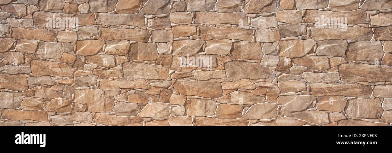 Braune Wandverkleidung aus Kunststoff in Steinoptik - Nachahmung einer Steinmauer Stockfoto