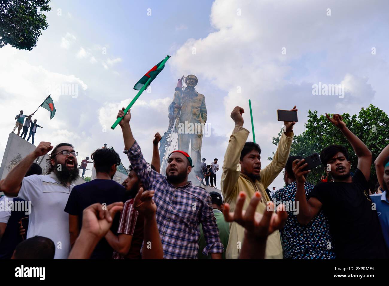 Dhaka, Bangladesch. August 2024. Die Menschen verwüsten eine Statue des ehemaligen Presdient Sheikh Mujibur Rahman, des Vaters von Premierminister Sheikh Hasina, in Dhaka, Bangladesch, am 5. August 2024. In einer Ansprache an die Nation kündigte der Chef des Armeestabs General Waker-UZ-Zaman an, dass Premierminister Scheich Hasina nach wochenlangen Unruhen zurückgetreten ist und eine Übergangsregierung gebildet wird, die das Land regieren soll. Stockfoto