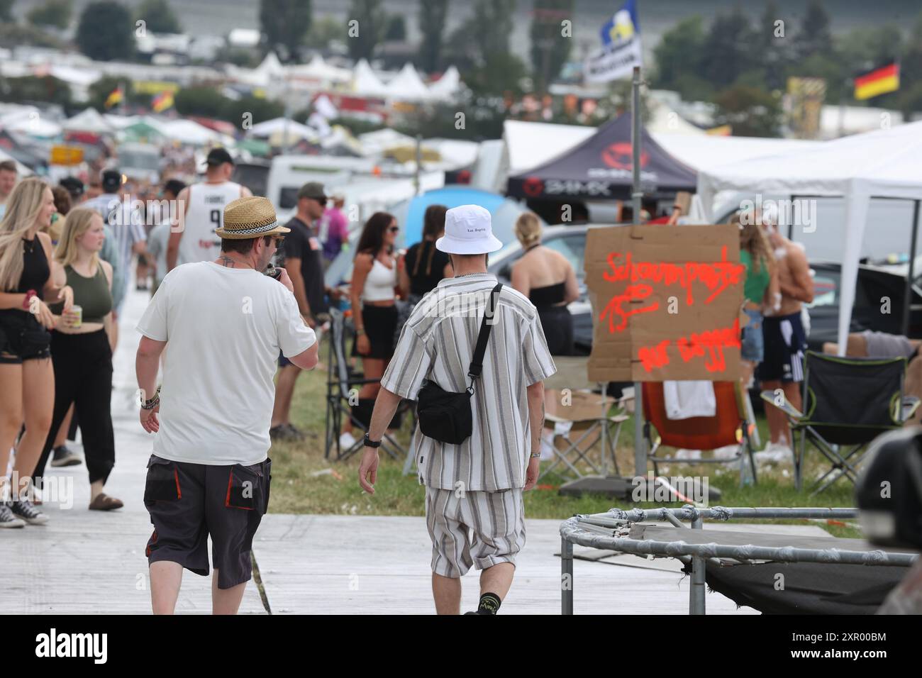 08. August 2024, Thüringen, Saalburg: Besucher kommen vor dem Start des Techno-Festivals SonneMondSterne an der Bleilochtalsperre zum Festivalgelände. Das SMS Festival ist eines der größten Open-Air-Musikfestivals für elektronische Tanzmusik in Deutschland. Foto: Bodo Schackow/dpa Stockfoto