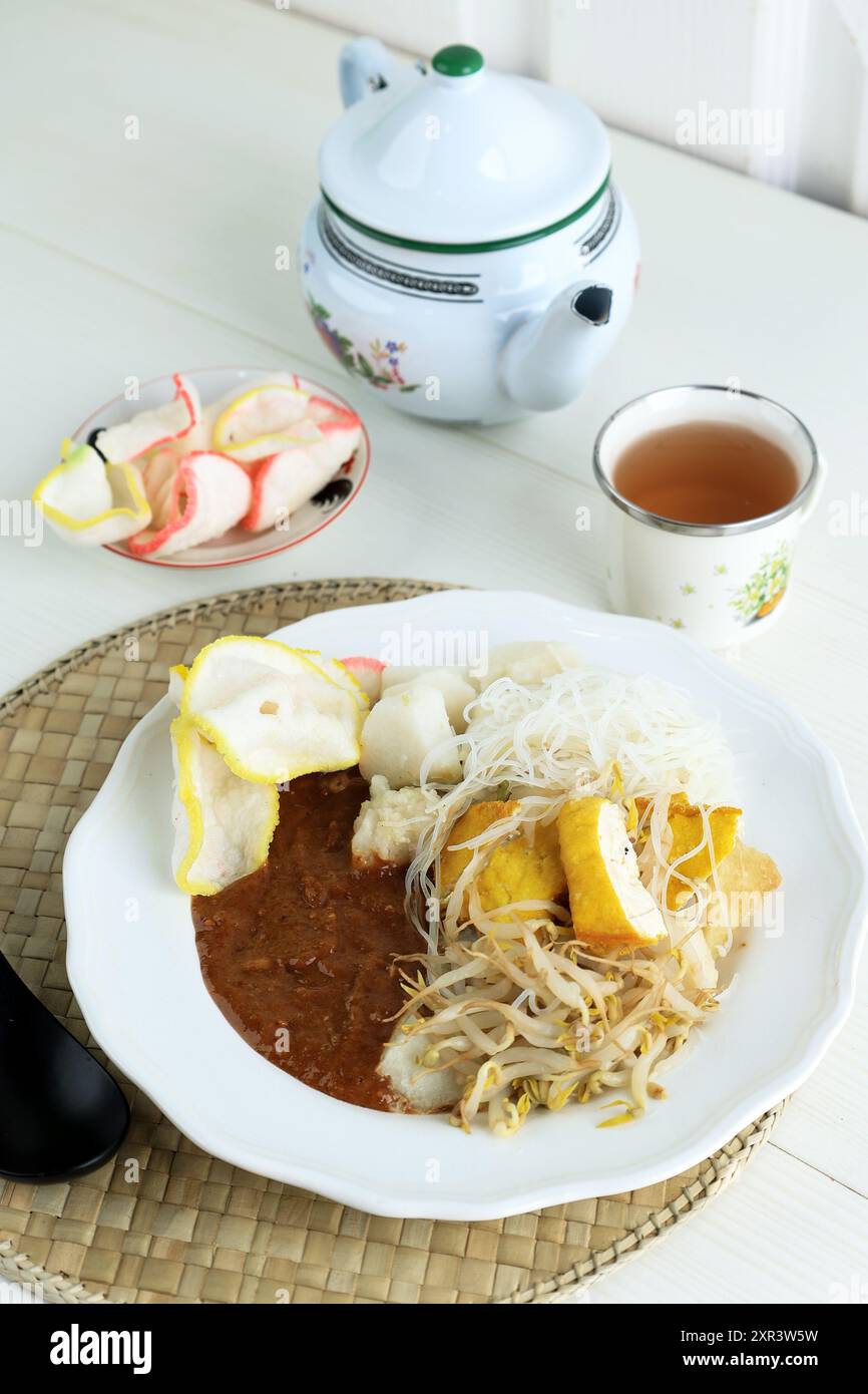 Ketoprak oder Kupat Tahu, beliebtes indonesisches Frühstück Stresst Essensmenü aus Lontong-Reiskuchen mit Tofu und gekochter Bohnensprosse Stockfoto