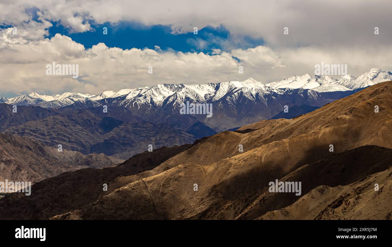 Ein Panoramablick auf schneebedeckte Bergketten mit Wolken am Himmel bei Ladakh Stockfoto