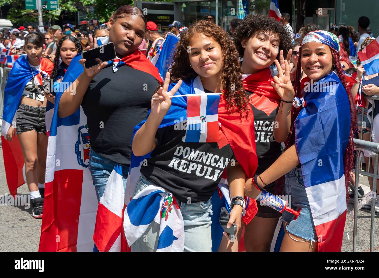 New York, Usa. August 2024. NEW YORK, NEW YORK - 11. AUGUST: Zuschauer mit Flagge der Dominikanischen Republik beobachten die Marschzüge bei der Dominican Day Parade auf der 6th Avenue am 11. August 2024 in New York City. Die National Dominican Day Parade feierte 42 Jahre Marsch auf der Sixth Avenue in Manhattan. Die Parade feiert dominikanische Kultur, Folklore und Traditionen. Quelle: Ron Adar/Alamy Live News Stockfoto