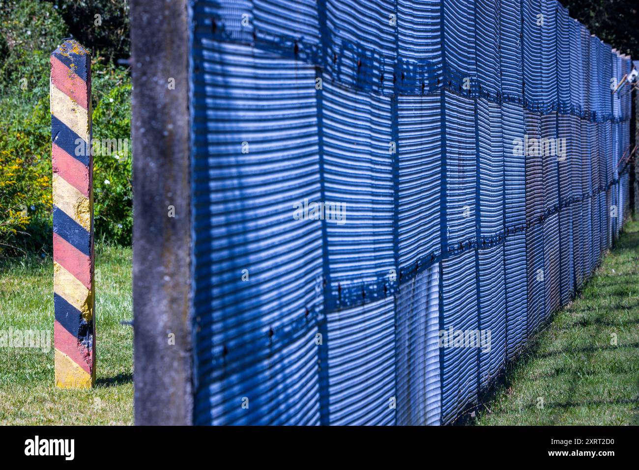 Schlagsdorf, Deutschland. August 2024. Eine Grenzsäule steht hinter dem Metallzaun der DDR-Grenztruppen auf dem Gelände des Grenzhus Schlagsdorf. Zahlreiche Veranstaltungen erinnern an den Tag des Mauerbaus und der Schließung der innerdeutschen Grenze am 13. August 1961. Historiker schätzen, dass an der innerdeutschen Grenze rund 650 Menschen ums Leben kamen. Quelle: Jens Büttner/dpa/Alamy Live News Stockfoto