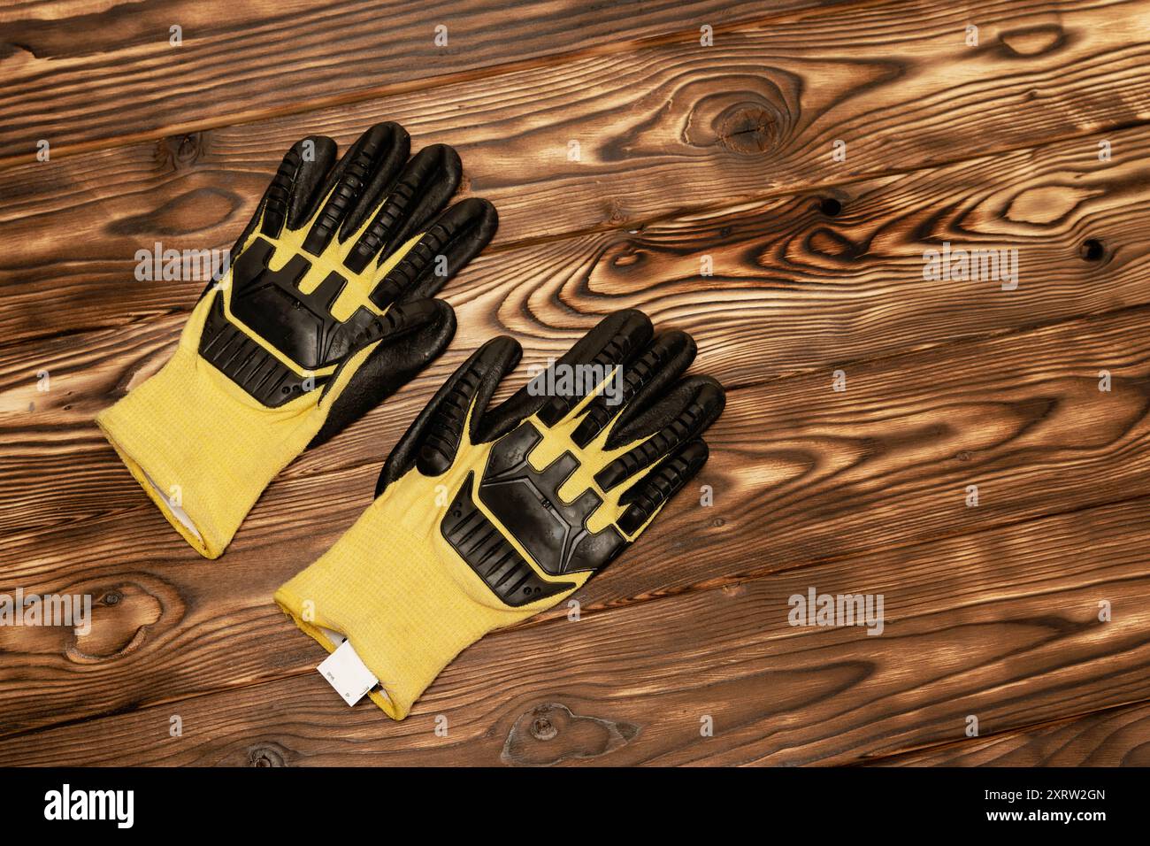 Ein Paar hellgelbe Arbeitshandschuhe mit verbessertem Schutz vor Schnitten und Stößen. Gummischutz Stockfoto